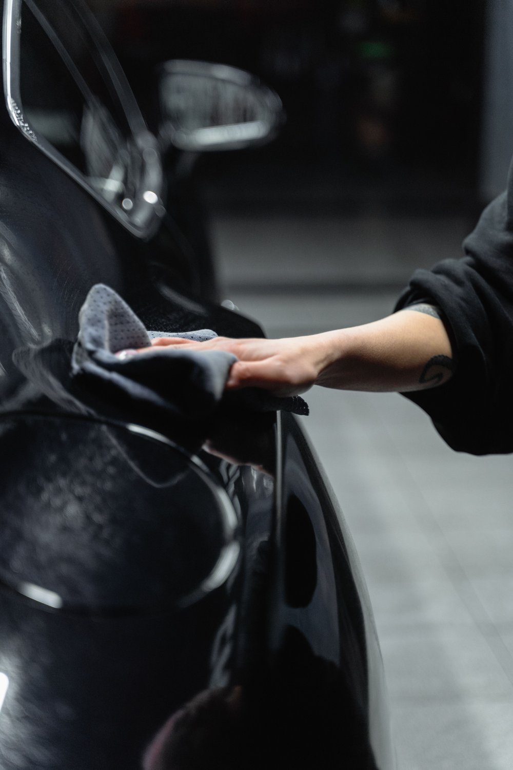 Hand polishing a car's paintwork for a glossy shine
